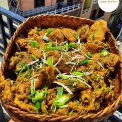A basket full of hot and crispy 'Bora' (fritters), ready to be served. These are perfect for a rainy day or as an appetizer for any party.