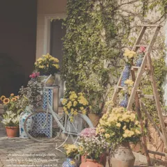 A whimsical photo corner with a rustic garden feel. We styled this nook with a vintage bicycle, a wooden ladder, and an abundance of flowers in terracotta pots and patterned vases.