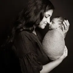 A timeless mother and child portrait, finished in a classic sepia tone to highlight the tender connection. These intimate shots are a beautiful part of any newborn session.