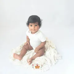 Look at those beautiful eyes. Sitter sessions are so special because your baby's personality is really starting to shine. My minimalist white backdrop ensures nothing distracts from their adorable expressions.
