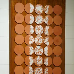 I love working on large-scale projects that transform a space. This custom wall installation features dozens of terracotta tiles, each with a unique white design, coming together to tell a story of nature and life cycles.