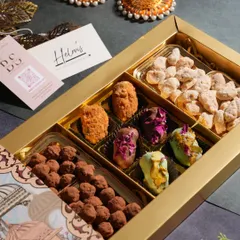 An elegant Diwali gift hamper filled with a variety of my handcrafted treats. This box includes chocolate truffles, assorted center-filled dates, and chai masala almonds.