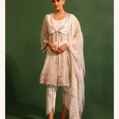 An all white look is timeless. This peplum style anarkali with delicate embroidery is perfect for everything from a festival to a wedding event.