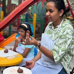 Here I am, guiding a student through the process of shaping clay. I focus on teaching techniques in a way that encourages personal exploration and builds confidence.