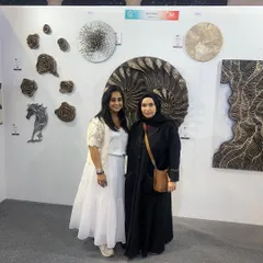 It's always an honor to meet fellow art lovers. Posing with a visitor at my booth during the art show in Qatar.
