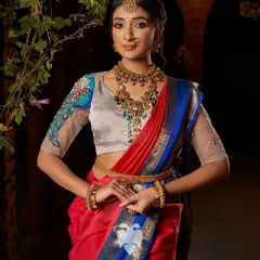 The Nemali Vanam blouse, where a resplendent peacock is sculpted with layered silk, sequins, and velvet tufts on a sheer nude base. This is a forest fantasy where every thread sings.