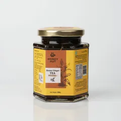 A jar of Honey Ginger Tea concentrate, photographed for an e-commerce listing. The clean reflection at the base adds a touch of professionalism.