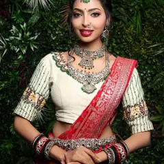 A classic bridal portrait is timeless. In this studio shot, I focused on creating a direct and engaging connection, highlighting the intricate silver jewelry and the rich texture of the red silk saree against a simple green backdrop.