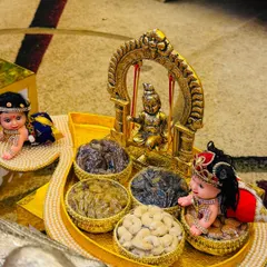 Every detail matters to me. This dry fruit platter for a naming ceremony was designed around a beautiful miniature of Lord Krishna on a swing, surrounded by small bowls of cashews and raisins, creating a divine and memorable gift.