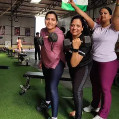 The strong women of Adapt Fitness Club. Here, we focus on building functional strength with exercises like dumbbell presses, empowering our members to feel capable and confident.