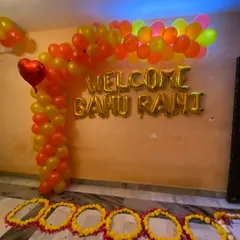 I also provide decorations for traditional ceremonies, like this 'Welcome Bahu Rani' setup for a newlywed bride. This features a custom balloon arch in festive colors and foil lettering to create a memorable welcome home moment for the new family member.