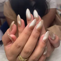 A beautiful example of a neutral cat eye effect on long, almond-shaped extensions. The magnetic polish creates a diagonal shimmer line that gives the nails depth and movement.