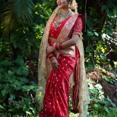 There is a special place in my heart for traditional wear. This client looks absolutely radiant in a classic red bridal saree from my collection, perfect for a wedding ceremony or a traditional photoshoot. The intricate gold work is timeless.