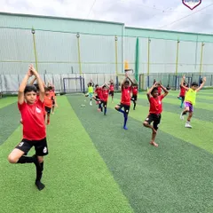 A group of our players practicing yoga together on the turf, connecting mind and body.