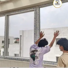 Our installation team works together to carefully position a large glass panel into the UPVC frame. This step requires coordination and precision to ensure the glass is seated correctly for a perfect seal and smooth operation, especially for large fixed or sliding windows.