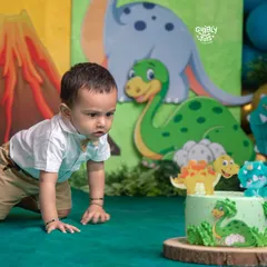 What's a birthday without a little bit of cake chaos? This curious little explorer is having a roaring good time with his dinosaur-themed cake smash.