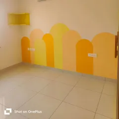 Another angle of the warm-toned arch mural, showing how it wraps around the corner of the room to create an immersive and playful environment.