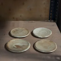 A set of four handmade plates, versatile enough to be used for cookies, desserts, or as coasters. These were thrown and glazed by our studio team, making each one a collaborative effort.