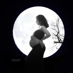 A powerful silhouette of the mother-to-be against a full moon. This dramatic, high-contrast black and white shot is both artistic and symbolic.