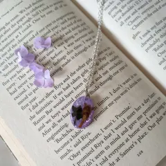 I also create wearable jewelry, like this custom resin pendant. It features a rare Neelakurinji flower preserved against a sparkling lavender background, hanging from a simple silver chain.
