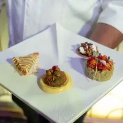 I present a quartet of flavours on a single plate. Each canapé, from the savory kebab to the delicate tart, is a distinct experience, designed to be savored one by one.