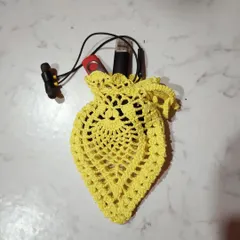Here is a yellow pineapple pouch being used to store earphones and a pen drive. It's the perfect size to prevent small electronics from getting lost in a larger bag.