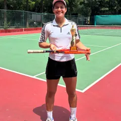 Posing with a well-earned trophy. Riya's back-to-back national titles are a testament to her relentless dedication.