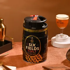 This image styles a Six Fields Cult beer keg in a bar-like setting, creating a moody and inviting atmosphere for an evening drink.