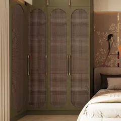 A close-up of an olive green wardrobe with unique oval-shaped cane paneling. This custom design adds a layer of texture and a touch of bohemian elegance to the bedroom, perfectly complementing the nature-themed wallpaper.