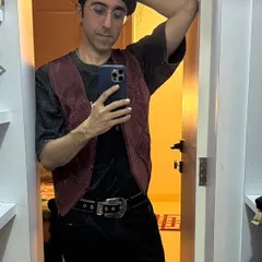 Another mirror selfie from a client. This shows the full outfit: a velvet vest over a tee, belted trousers, and a statement beret. It’s a great example of a non-traditional, stylish look for a night out.