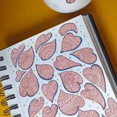 A page from my sketchbook filled with detailed, heart-shaped doodles, drawn as a form of meditation on a tough day.