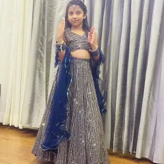 A happy little client in a sparkling navy blue and silver sequin lehenga. This custom outfit is perfect for a reception or evening party.
