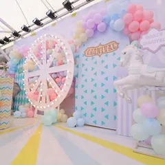 A closer look at the pastel carnival stage, highlighting the carousel horse and illuminated Ferris wheel. The soft pastel balloons and striped details create a whimsical and sweet atmosphere for a little one's celebration.