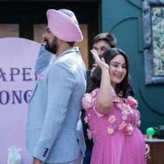 A candid moment of fun and games at the baby shower. This shot captures the couple's playful side and the joyful, relaxed atmosphere of the event.