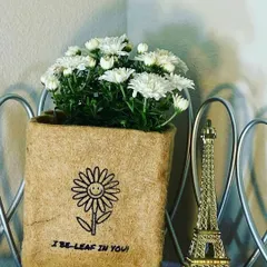 My eco-friendly grow bags come with a little personality. This one, holding a lovely bunch of white Chrysanthemums, has a fun quote: 'I BE-LEAF IN YOU'. It’s a small detail that makes a gift feel extra special and personal.