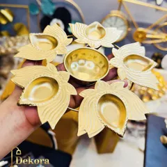 A close-up of our handcrafted metal diya holder, designed in a lotus formation. This piece shows the detailed metalwork and quality finish that goes into every festive item we manufacture.