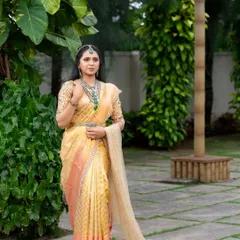 This look from my 'Athiloka Sundari' series features me in a pure Kanchi saree. I paired it with a blouse adorned with intricate embroidery and semi-precious stone embellishments, creating a regal outfit designed to make any bride feel like a princess.