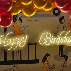 A close-up of the neon "Happy Birthday" sign used at a celebration at The Bier Library. This element adds a modern and celebratory glow to any event space.