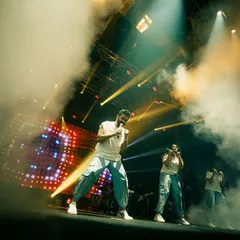 A high-energy moment from a live show, capturing the artists in their element amidst smoke and spotlights. My choreography aims to amplify the performer's energy and connect them with the crowd.