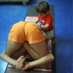 This is an old photo from 2017 with my little nephew, Moksh, who was one of my first "teachers." Children are naturally flexible and present, and he would often come to "adjust" me in poses like this Pindasana. It is a joyful memory of how practice is intertwined with family.