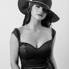 A timeless black and white portrait that plays with shadow and mystery. The wide-brimmed hat conceals just enough to draw you in, showcasing a classic, elegant look perfect for a high-fashion portfolio.
