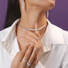 A diamond's sparkle says it all. This classic diamond tennis necklace, paired with matching waterfall earrings and rings, creates a feeling of pure, understated luxury.