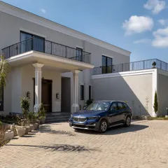 The arrival experience is the first chapter of a home's story. The paved driveway and stately entrance of this villa create a sense of occasion, welcoming residents and guests into a world of bespoke design.