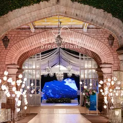 Another view of the entrance walkway, this time flanked by modern, geometric glass installations that reflect the light and add a contemporary touch.