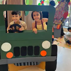 After creating a jungle, you need a jeep to explore it. Here, two friends are ready for an imaginative safari in a cardboard jeep they helped create. Our workshops go beyond painting; we build worlds and then play in them, sparking storytelling and creative play.