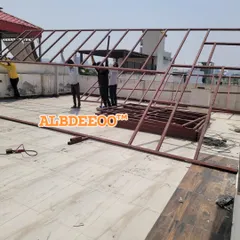 Our team assembling a large MS roof truss on a terrace. The frame is prefabricated for precision and then quickly put together on-site, forming the strong skeleton of the structure.