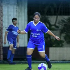 We champion girls in football, providing a supportive environment for them to excel. This photo shows one of our dedicated female players skillfully maneuvering the ball, demonstrating the technical proficiency we cultivate in our academy.