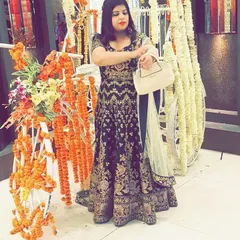 The same client at a wedding event, showing how the Anarkali looks in a festive setting. The rich color and detailed work make it stand out beautifully.