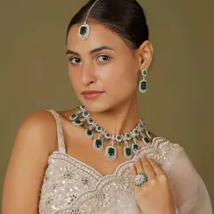 For the modern bride who loves a touch of sparkle, this emerald and American diamond set is a perfect choice. It combines contemporary design with traditional elegance, making it ideal for a reception or sangeet night.