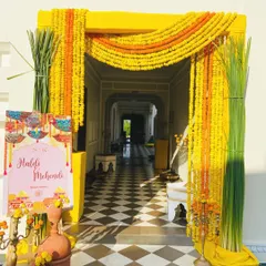 The energy of a Haldi ceremony starts at the entrance. I used bold yellow framing and dense strings of traditional marigolds to create a vibrant and joyful welcome that sets the tone for the fun-filled event ahead.